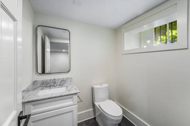 bathroom with toilet and vanity