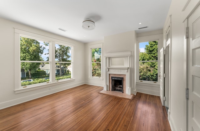 unfurnished living room with dark hardwood / wood-style flooring