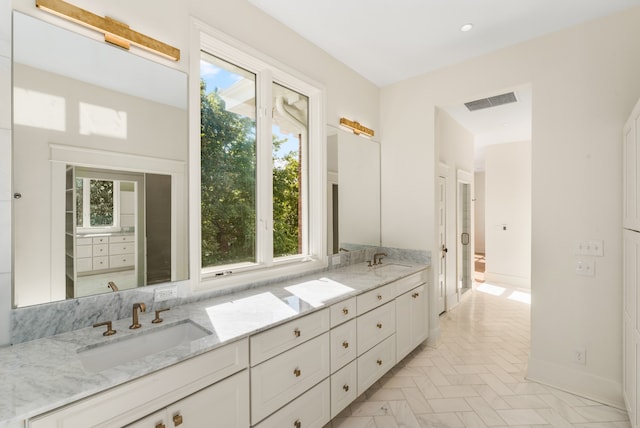 bathroom featuring dual vanity