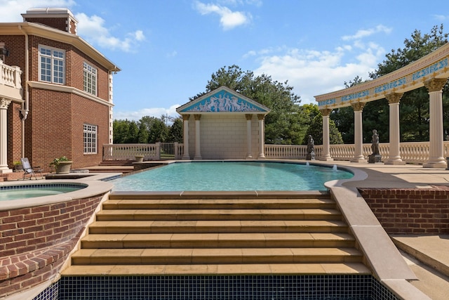 view of pool with a patio area and a hot tub