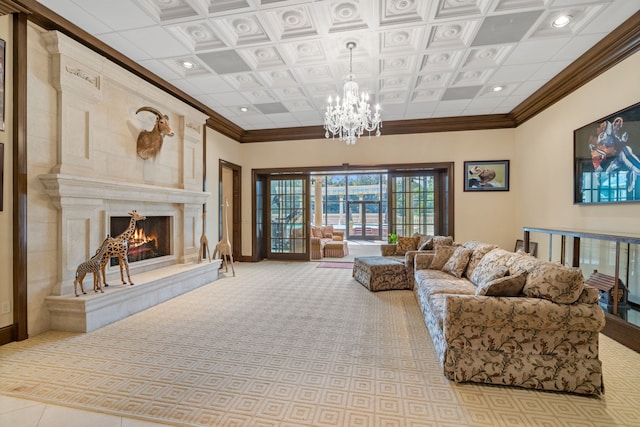 living room featuring coffered ceiling, an inviting chandelier, crown molding, a fireplace, and a high ceiling