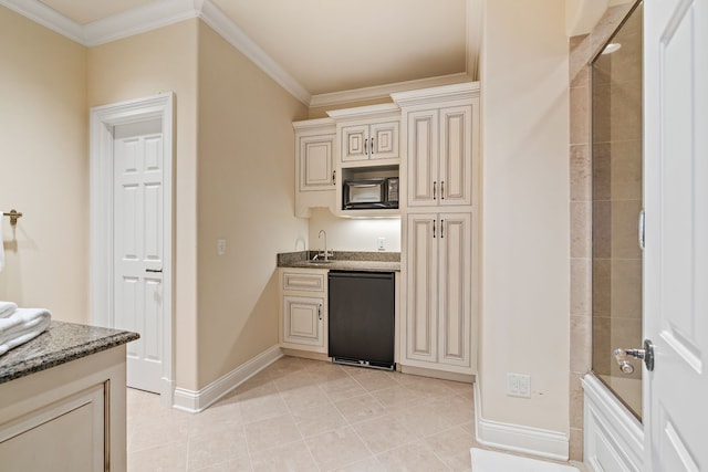 kitchen featuring ornamental molding, light tile flooring, stone countertops, black appliances, and cream cabinets