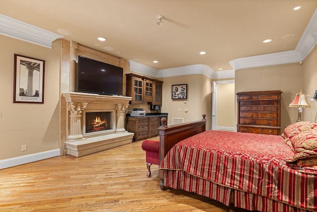 bedroom with light hardwood / wood-style flooring and crown molding