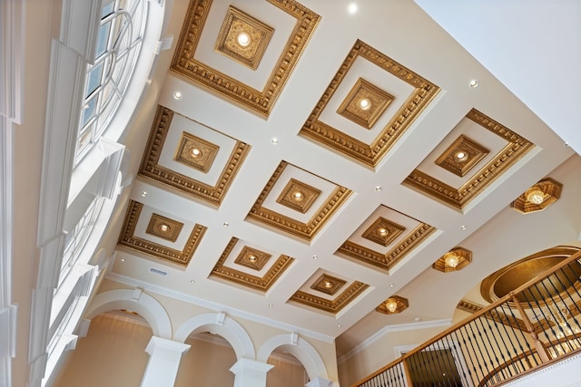 interior space featuring coffered ceiling and ornamental molding