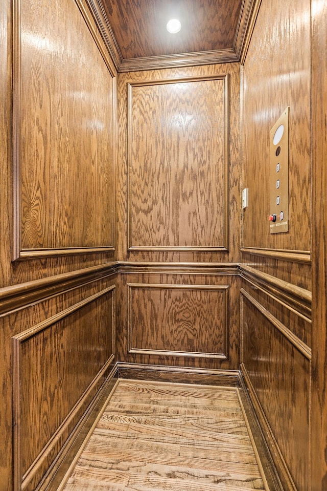 room details with wooden ceiling, elevator, wood walls, and wood-type flooring