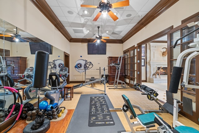 exercise area featuring ceiling fan, coffered ceiling, and a towering ceiling