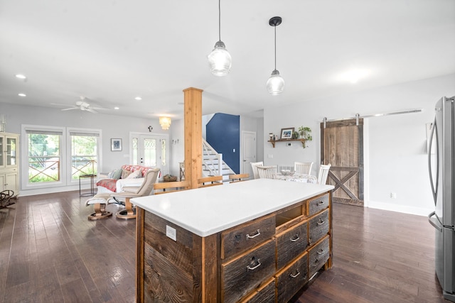 554 Hayes Ridge Rd, Indian Mound, TN 37079 - kitchen featuring hanging light fixtures, dark hardwood / wood-style floors, ceiling fan, stainless steel fridge, and a barn door