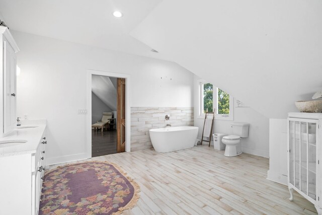 554 Hayes Ridge Rd, Indian Mound, TN 37079 - bathroom featuring tile walls, toilet, wood-type flooring, vaulted ceiling, and dual vanity