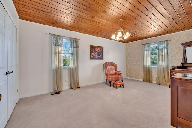 sitting room with wood ceiling, light colored carpet, and a chandelier