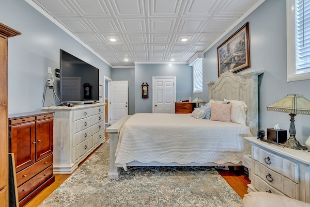 bedroom with dark hardwood / wood-style flooring and multiple windows