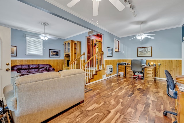 living room featuring ceiling fan, crown molding, and light wood-type flooring