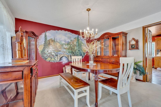 dining area with light colored carpet, a notable chandelier, and a textured ceiling