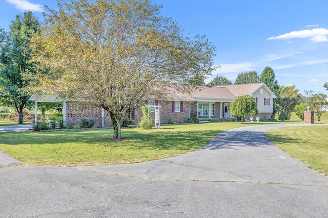 ranch-style home featuring a front yard