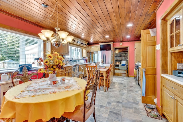 tiled dining space featuring a chandelier and wooden ceiling