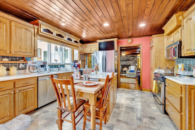 kitchen with light tile floors, a fireplace, wooden ceiling, appliances with stainless steel finishes, and backsplash