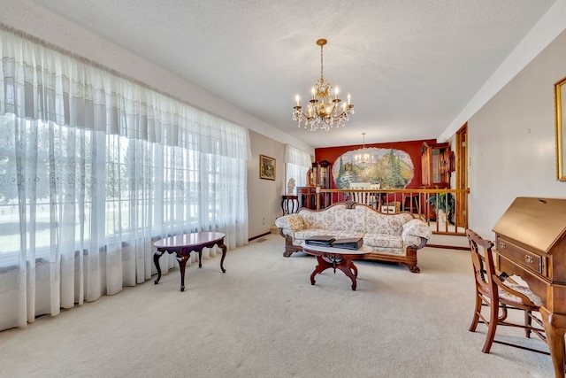 carpeted living room with a notable chandelier and a textured ceiling