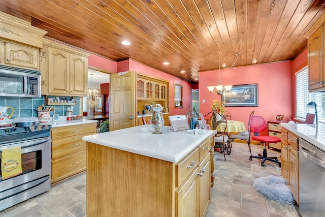 kitchen featuring pendant lighting, appliances with stainless steel finishes, a chandelier, backsplash, and a center island