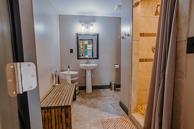 bathroom featuring tile floors, sink, and tiled shower