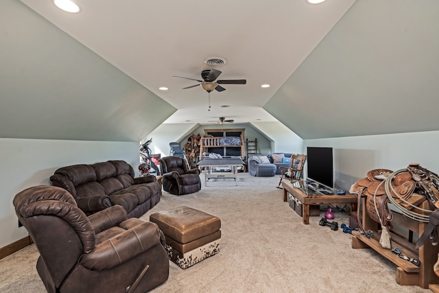 carpeted living room with ceiling fan and vaulted ceiling