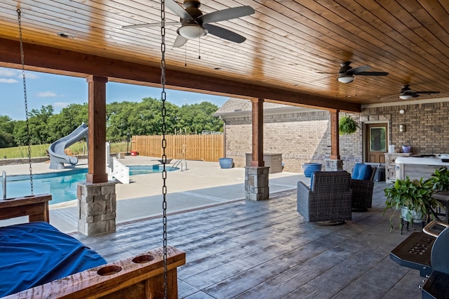 view of patio featuring a pool side deck and ceiling fan