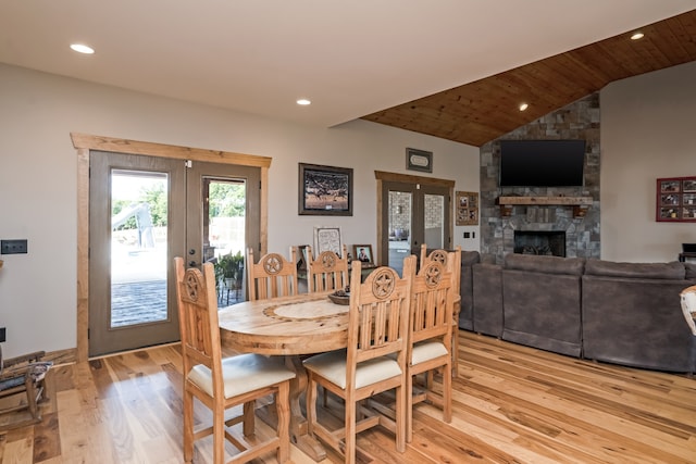 dining room featuring french doors, wood ceiling, lofted ceiling, and light wood-type flooring