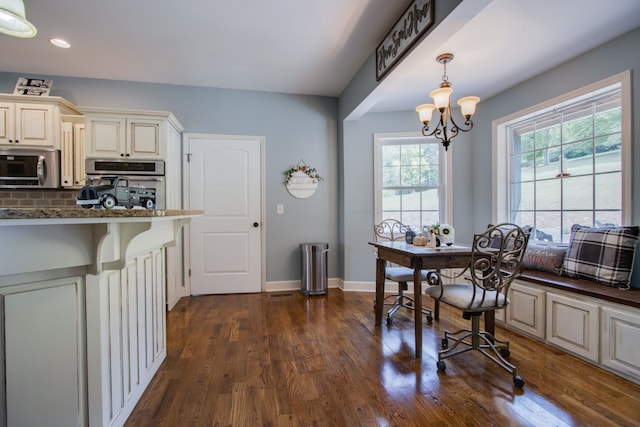 dining space with an inviting chandelier and dark wood-type flooring