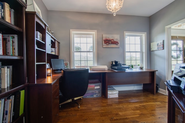 office with plenty of natural light, dark hardwood / wood-style flooring, and an inviting chandelier