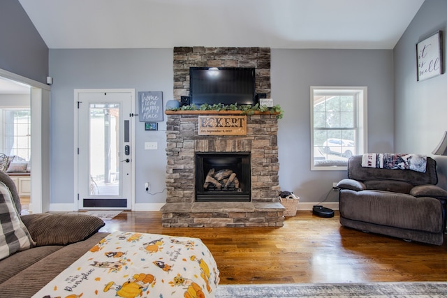 living room featuring a fireplace, dark wood-type flooring, and lofted ceiling