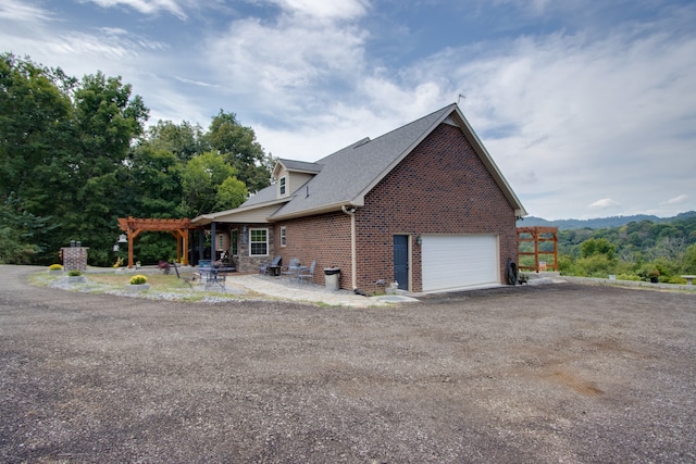 view of front of house featuring a pergola and a garage