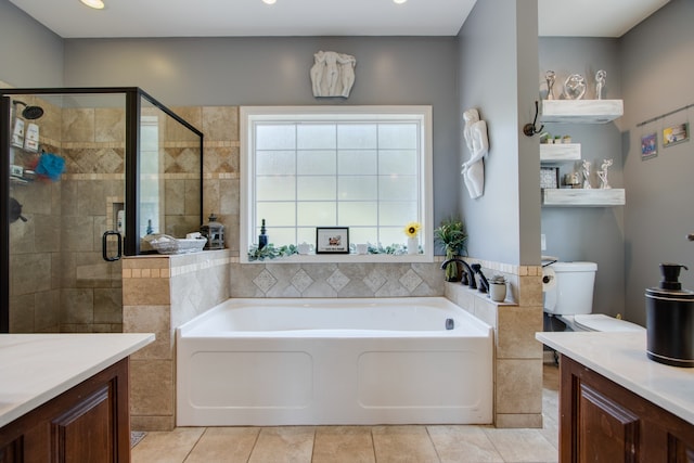 full bathroom featuring shower with separate bathtub, tile floors, toilet, and vanity