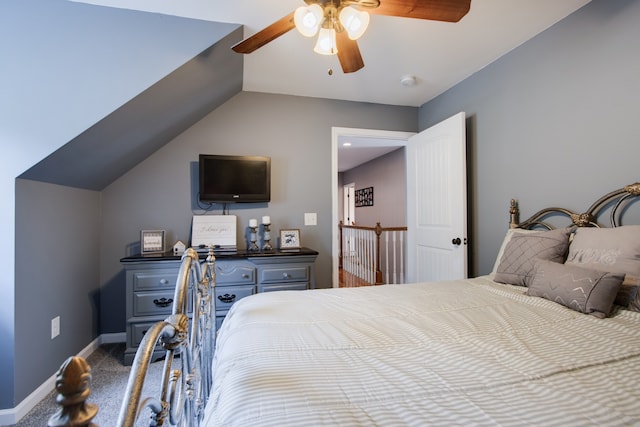 bedroom with ceiling fan, carpet, and vaulted ceiling