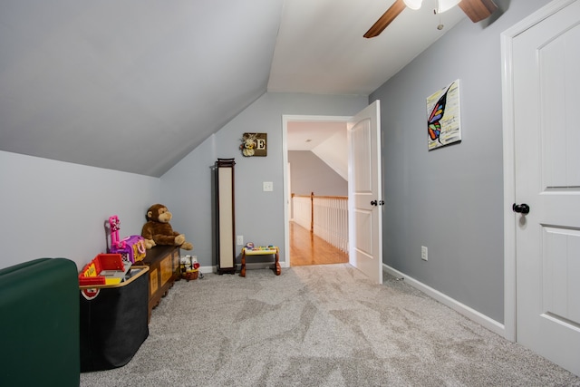 game room featuring light colored carpet, vaulted ceiling, and ceiling fan