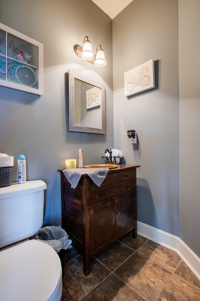 bathroom featuring vanity, tile floors, and toilet