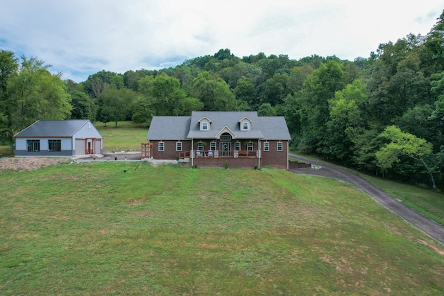 cape cod home with a front lawn