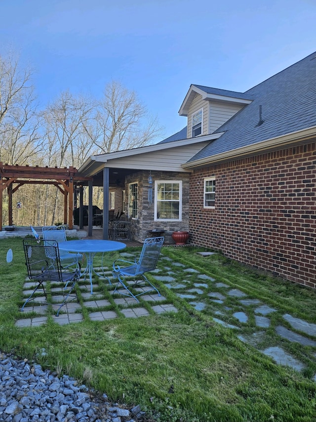 back of house featuring a yard and a patio area