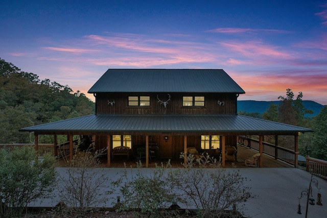 view of back house at dusk