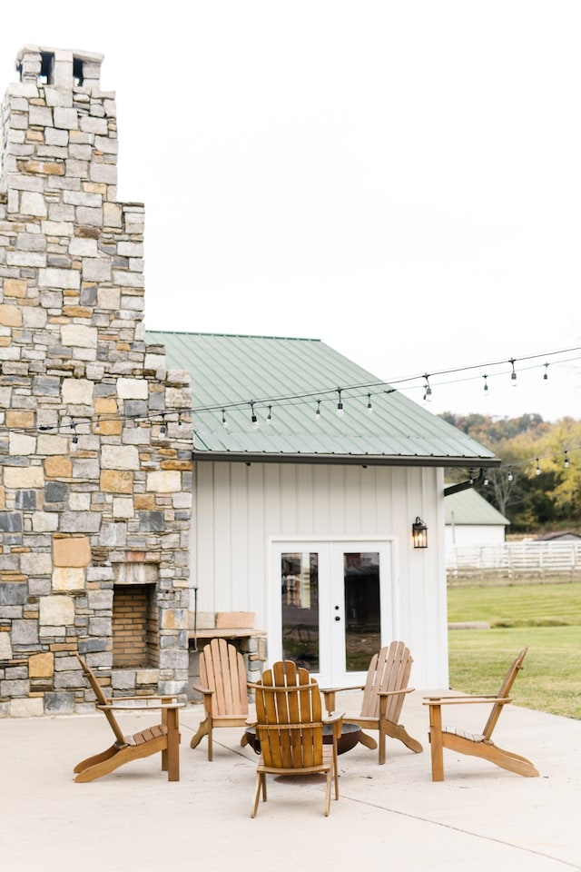 exterior space with a patio, french doors, and an outdoor stone fireplace