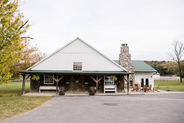 view of front of property with a patio area and a front lawn