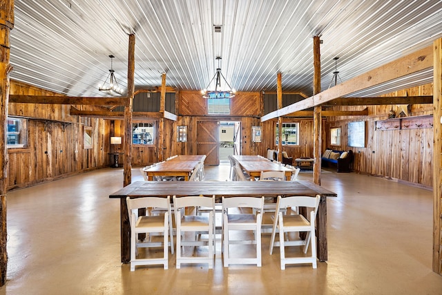 dining room with wooden walls