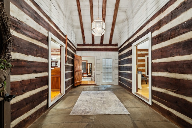 interior space with wood walls and vaulted ceiling with beams