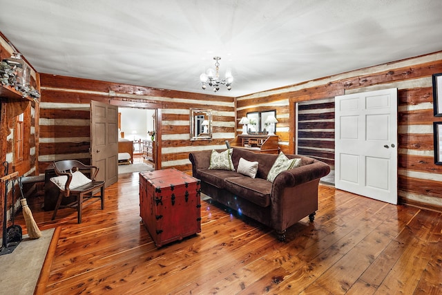 living room featuring a notable chandelier, rustic walls, and dark hardwood / wood-style floors