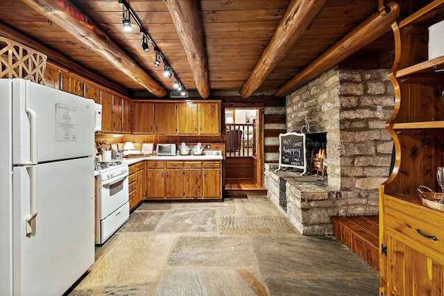 kitchen with wooden ceiling, track lighting, a fireplace, white appliances, and beam ceiling