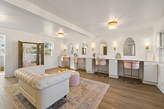 living room with beam ceiling and wood-type flooring