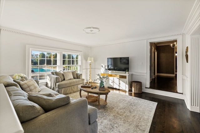 living room featuring dark wood-type flooring and crown molding