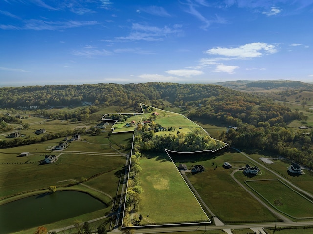 drone / aerial view featuring a rural view and a water view