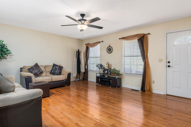 living room featuring ceiling fan and light hardwood / wood-style flooring