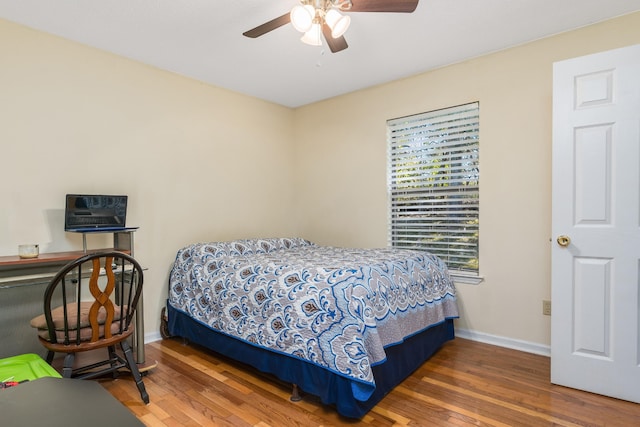 bedroom featuring dark hardwood / wood-style flooring and ceiling fan