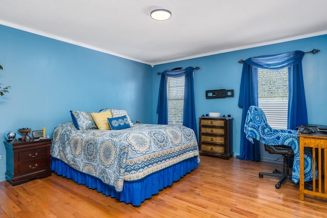 bedroom with crown molding and wood-type flooring