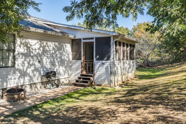 rear view of house featuring a yard