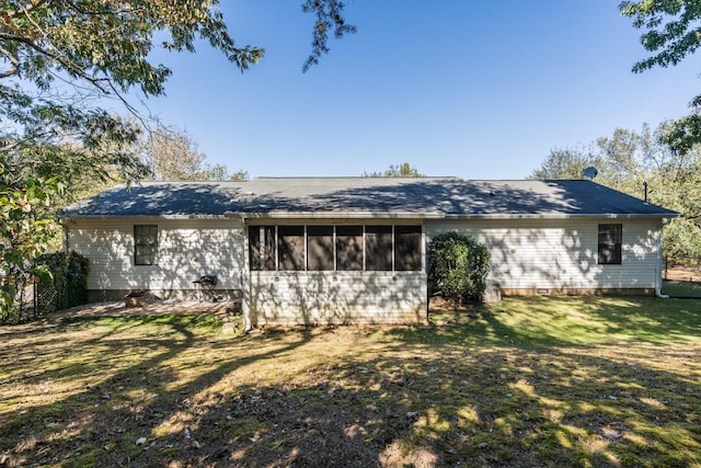 rear view of house with a yard